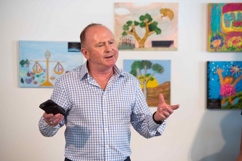 Man introducing people to art exhibition at Having a Say Conference