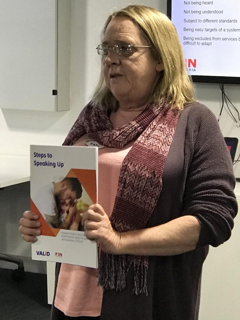 Kate holding a pamphlet